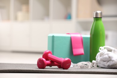 Many different sports equipment on floor indoors, space for text