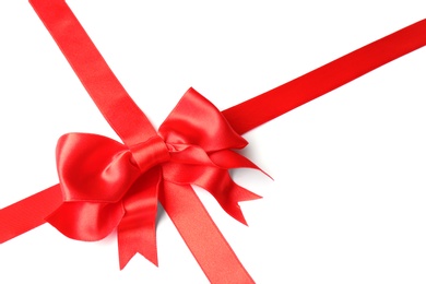 Photo of Red ribbon with bow on white background. Festive decoration