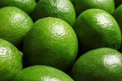 Photo of Fresh ripe green limes as background, closeup