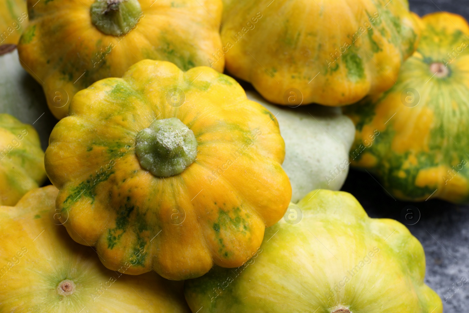 Photo of Fresh ripe pattypan squashes on table, closeup