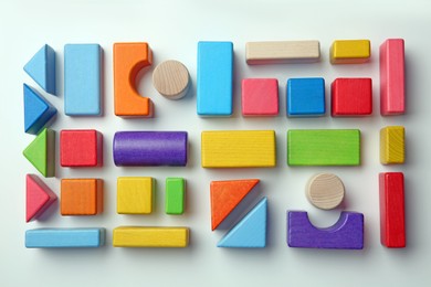 Photo of Colorful wooden construction set on white background top view