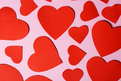 Photo of Paper hearts on color background, top view