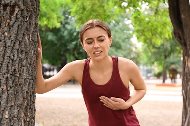 Photo of Young woman having heart attack while running in park