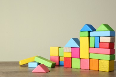 Photo of Many colorful building blocks for ABA therapy on wooden table. Space for text