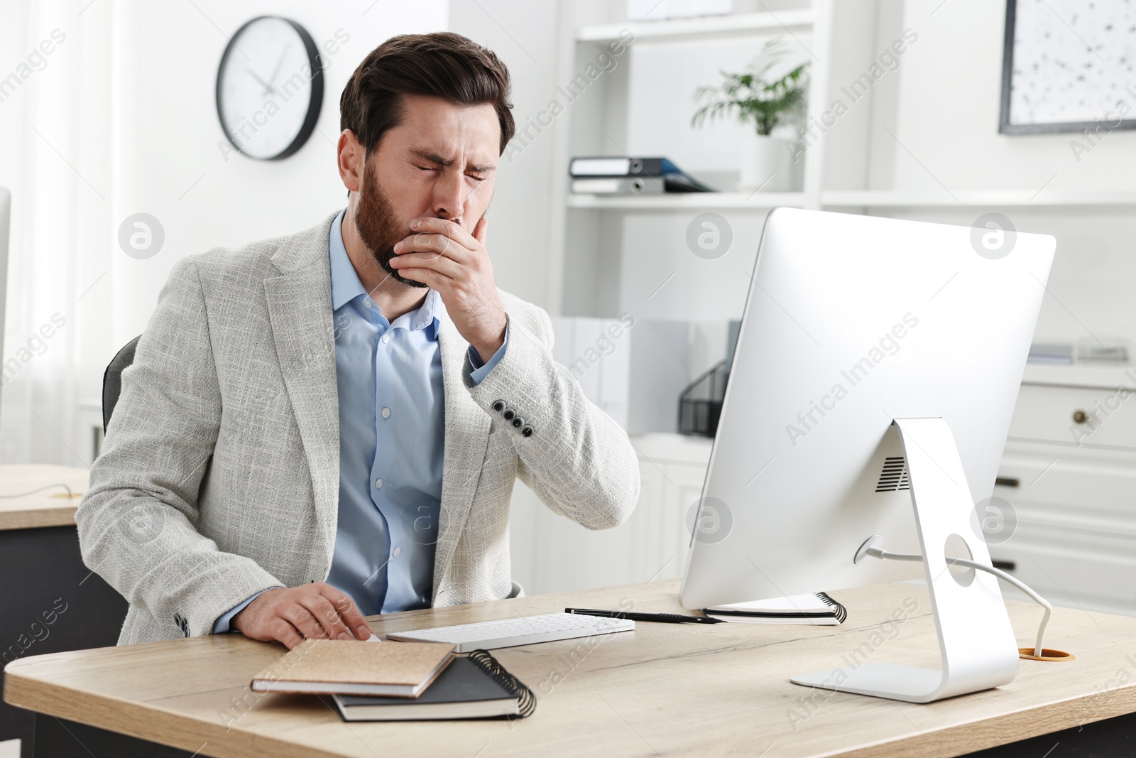 Photo of Sick man coughing at workplace in office. Cold symptoms