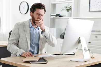 Sick man coughing at workplace in office. Cold symptoms