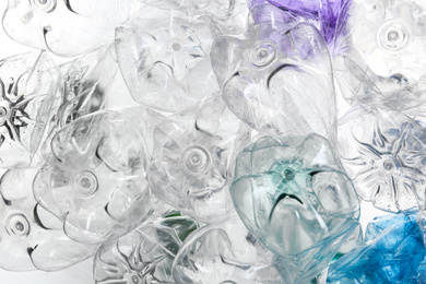 Many crumpled bottles as background, closeup. Plastic recycling