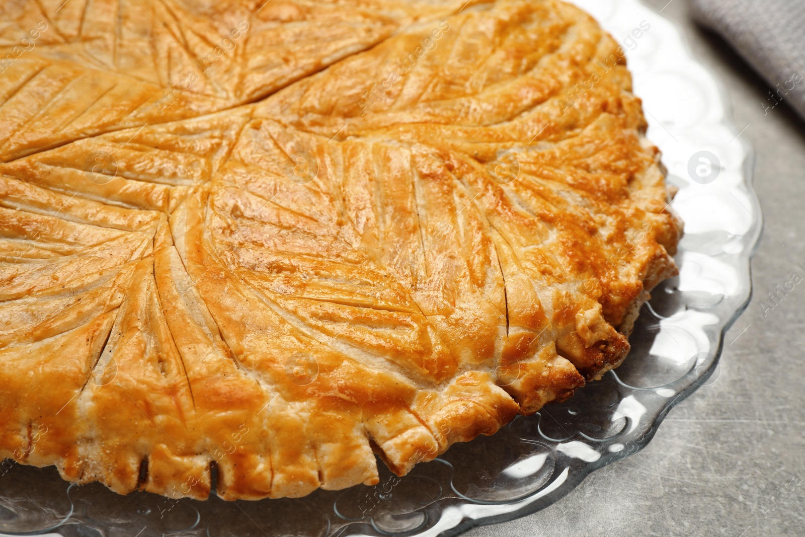 Photo of Traditional galette des rois on light grey table, closeup