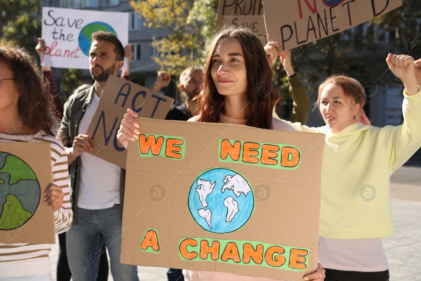 Photo of Group of people with posters protesting against climate change on city street