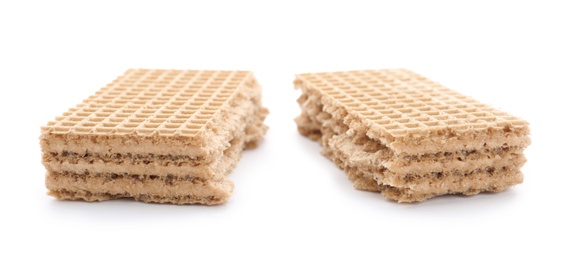 Photo of Delicious broken crispy wafer on white background. Sweet food