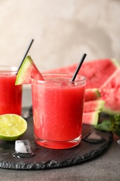 Photo of Tasty summer watermelon drink in glass served on table