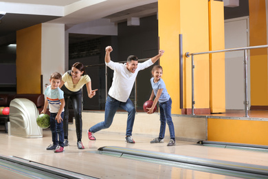 Photo of Happy family spending time together in bowling club