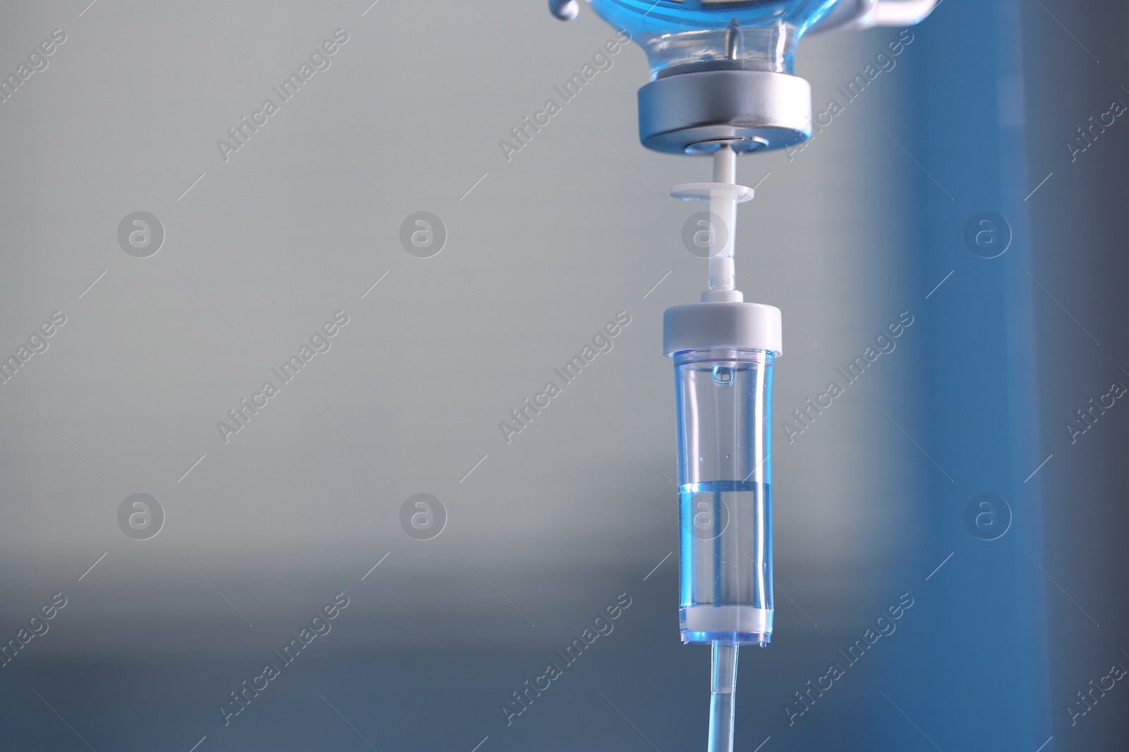 Photo of IV drip against blurred background, space for text