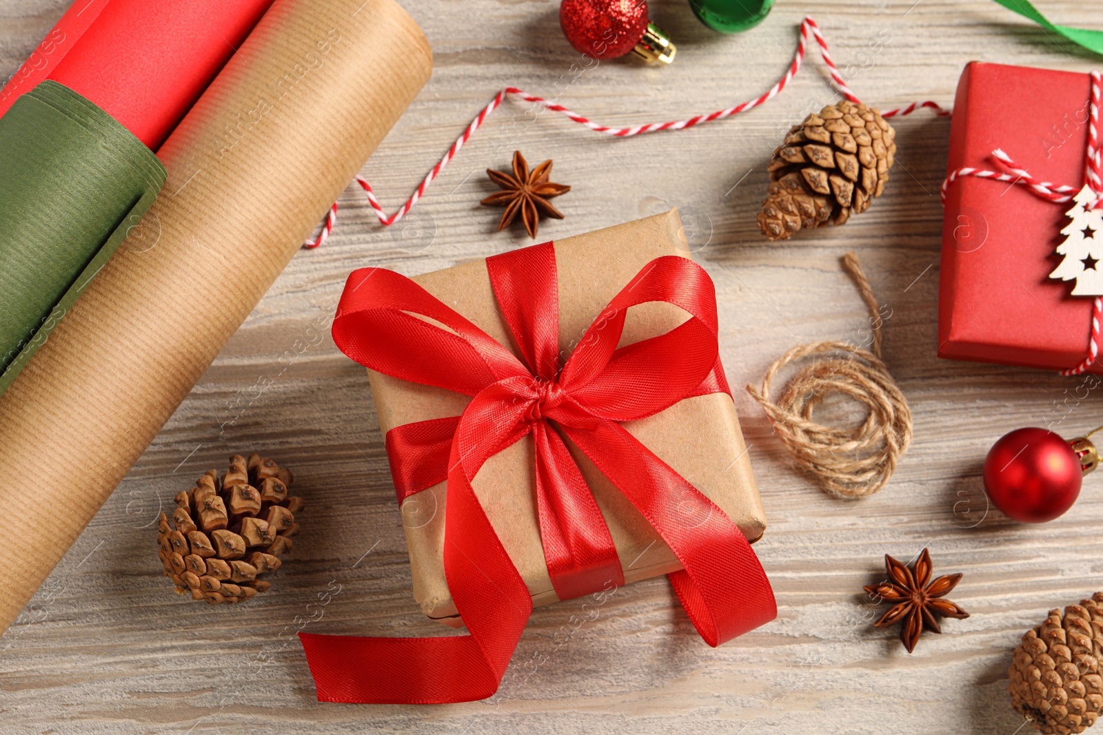 Photo of Flat lay composition with beautiful gift boxes and Christmas decorations on white wooden table