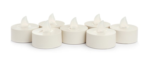 Photo of Decorative flameless LED candles on white background