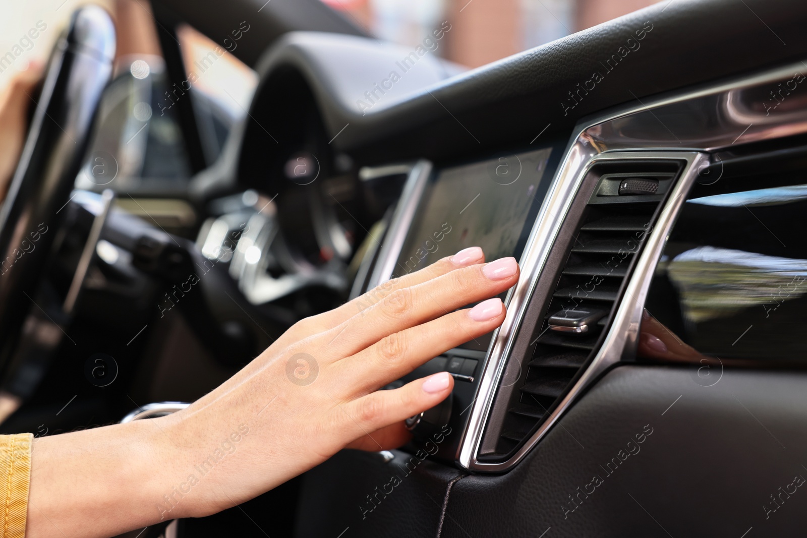 Photo of Woman checking air conditioner in her car, closeup