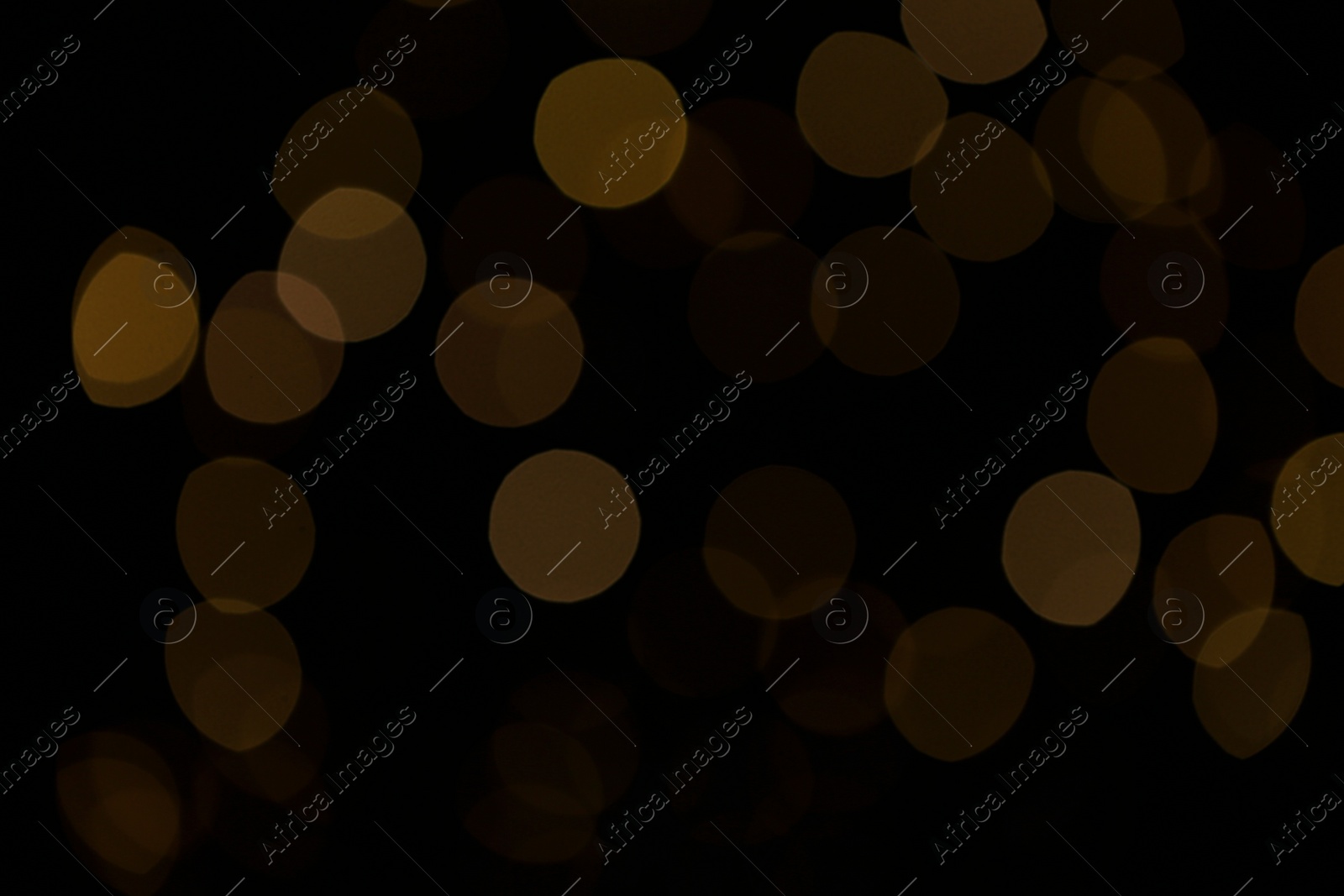 Photo of Blurred view of beautiful lights on black background. Bokeh effect