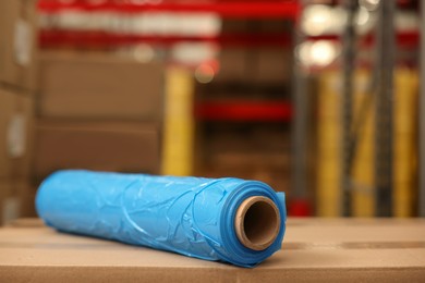 Photo of Roll of stretch wrap on boxes in warehouse