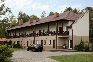 Photo of Beautiful two storey beach house and green trees outdoors