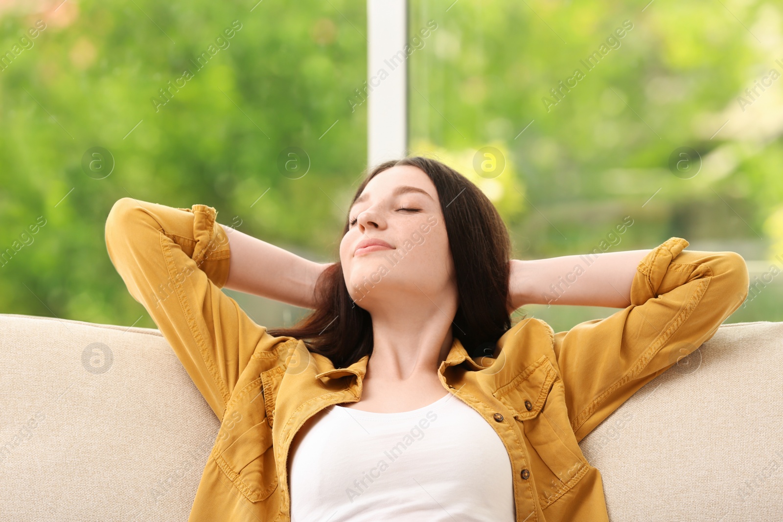 Photo of Teenage girl relaxing on sofa at home