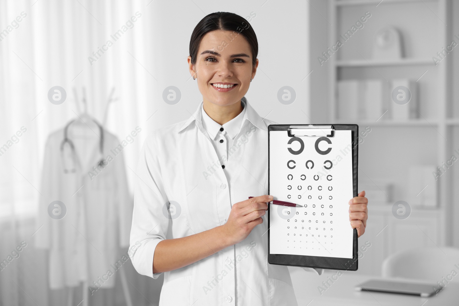 Photo of Ophthalmologist pointing at vision test chart in clinic