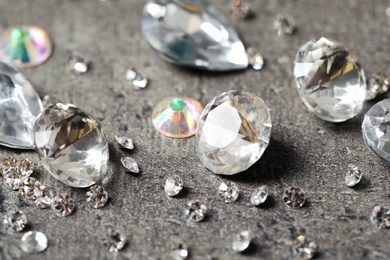 Beautiful gemstones for jewelry on grey background, closeup