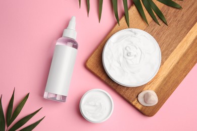 Photo of Flat lay composition with different cosmetic products on pink background