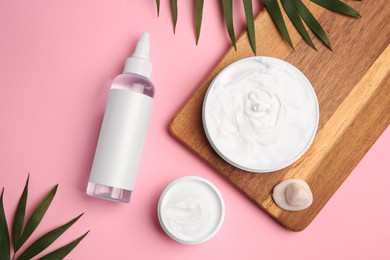 Flat lay composition with different cosmetic products on pink background