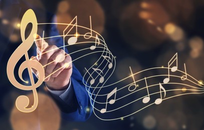 Image of Musician pointing at staff with music notes and treble clef on color background, closeup