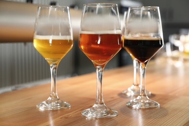 Different sorts of beer on wooden bar counter