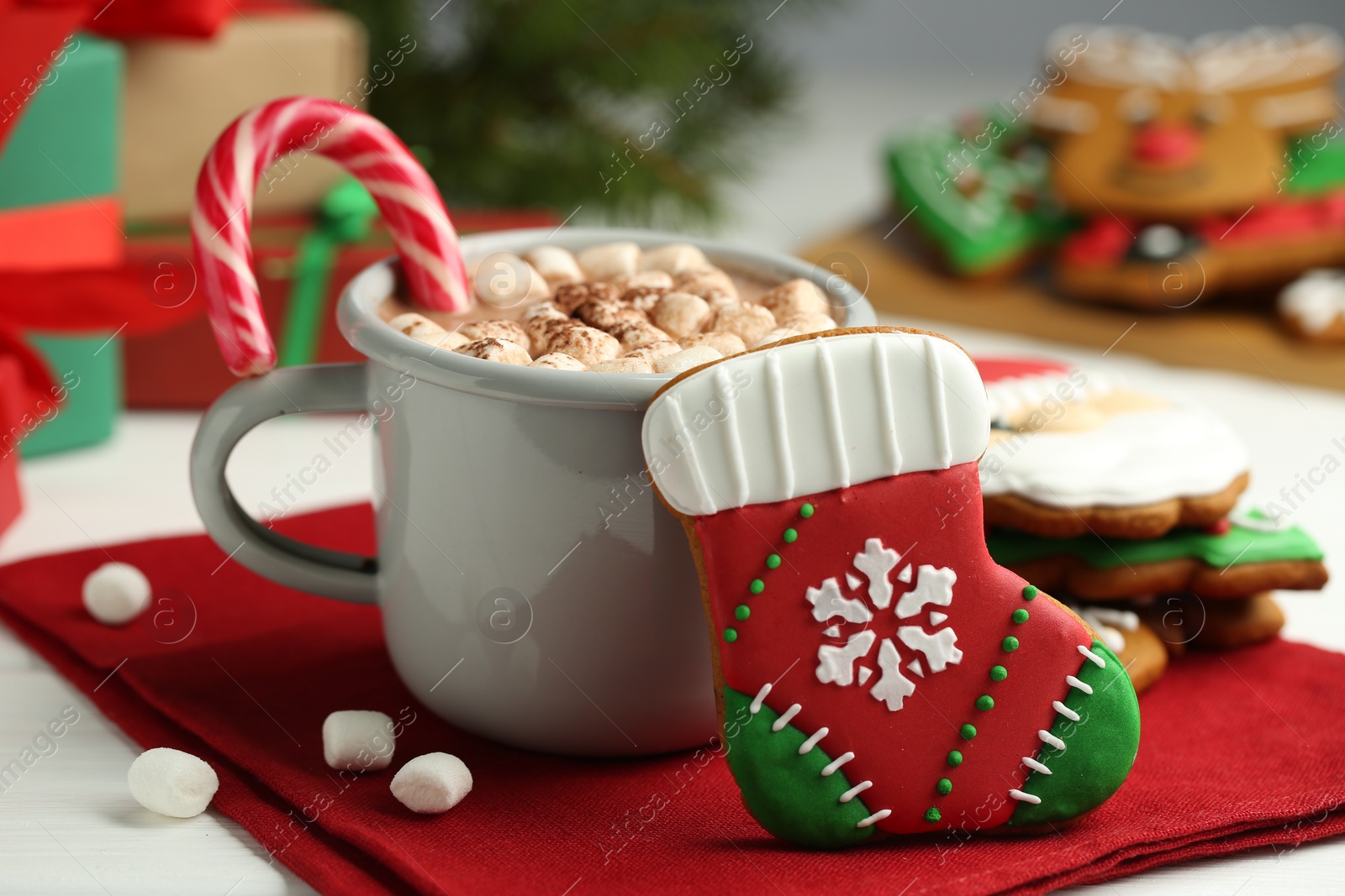 Photo of Tasty homemade Christmas cookie and hot chocolate with marshmallows on white table, closeup