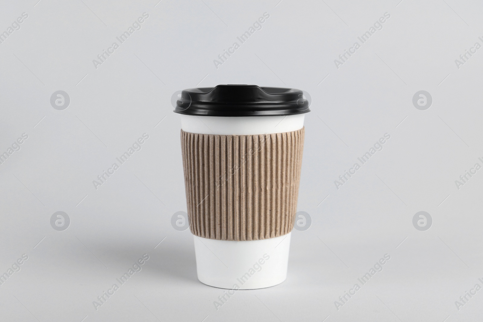 Photo of Paper cup with plastic lid on light background. Coffee to go