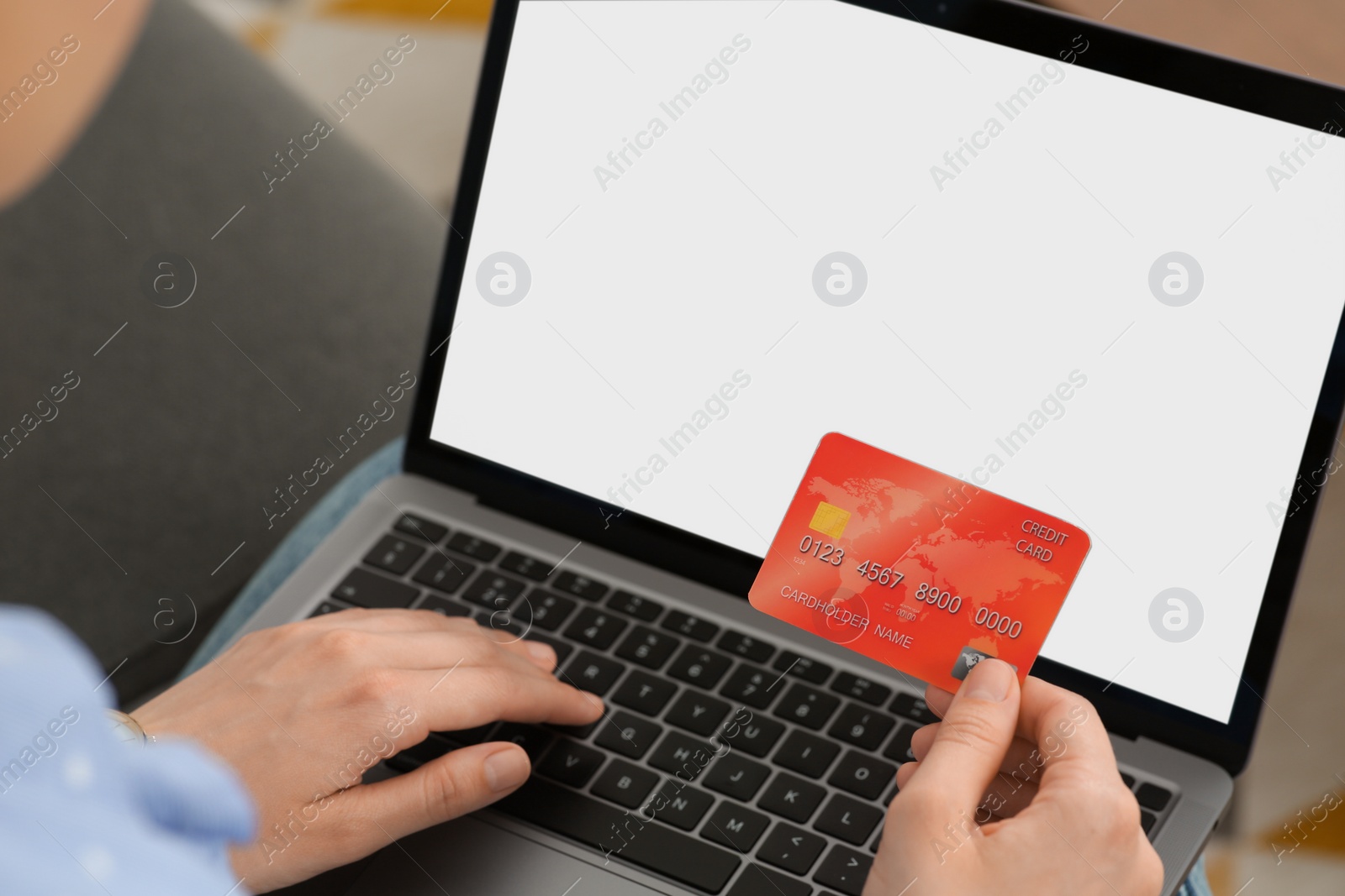 Photo of Woman with credit card using laptop for online shopping, closeup