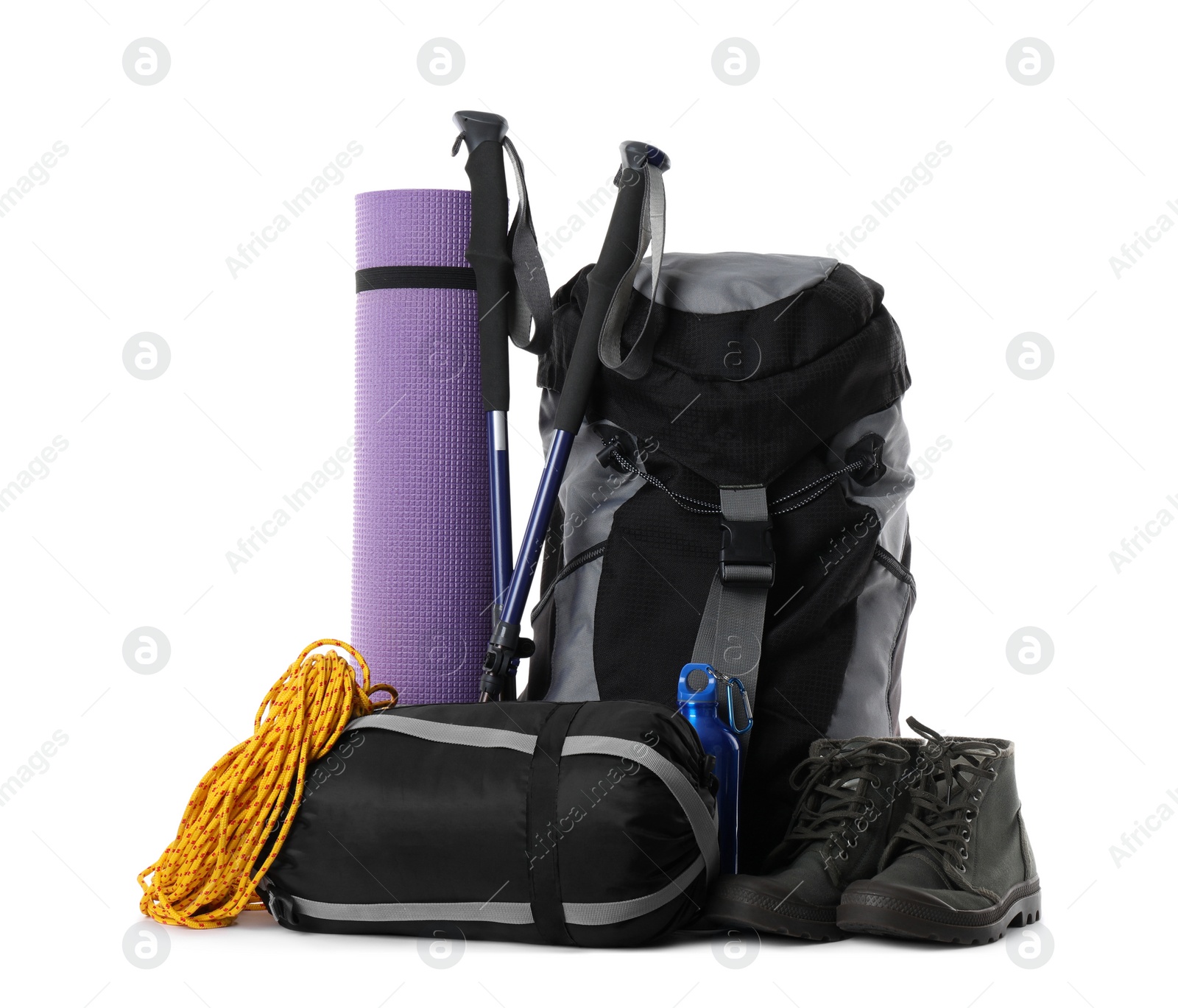 Photo of Pair of trekking poles and camping equipment for tourism on white background