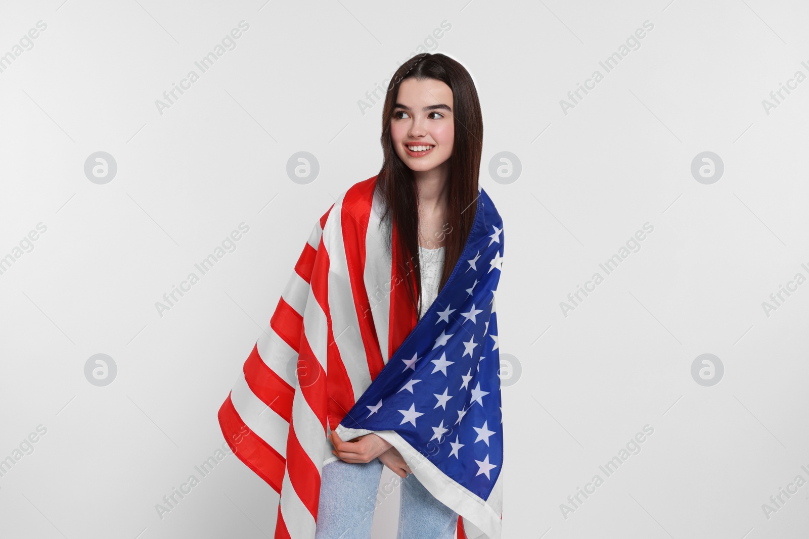 Photo of 4th of July - Independence Day of USA. Happy girl with American flag on white background