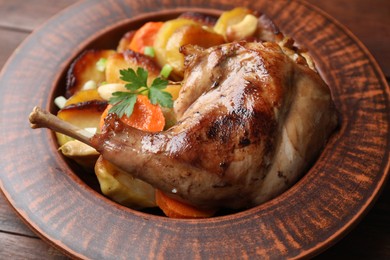 Photo of Tasty cooked rabbit meat with vegetables on table, closeup