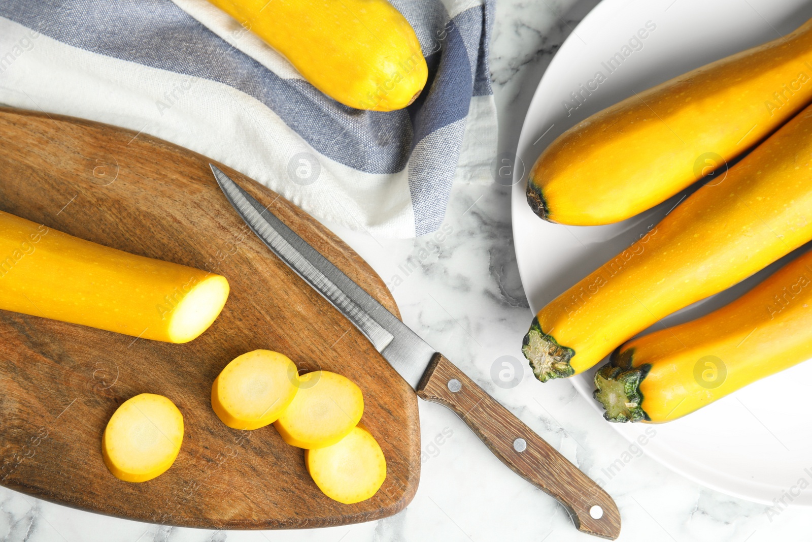 Photo of Flat lay composition with fresh ripe yellow zucchinis on marble table