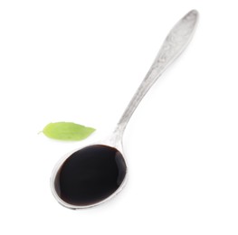 Photo of Metal spoon with balsamic glaze and basil leaf on white background