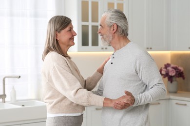 Photo of Senior couple spending time together in kitchen