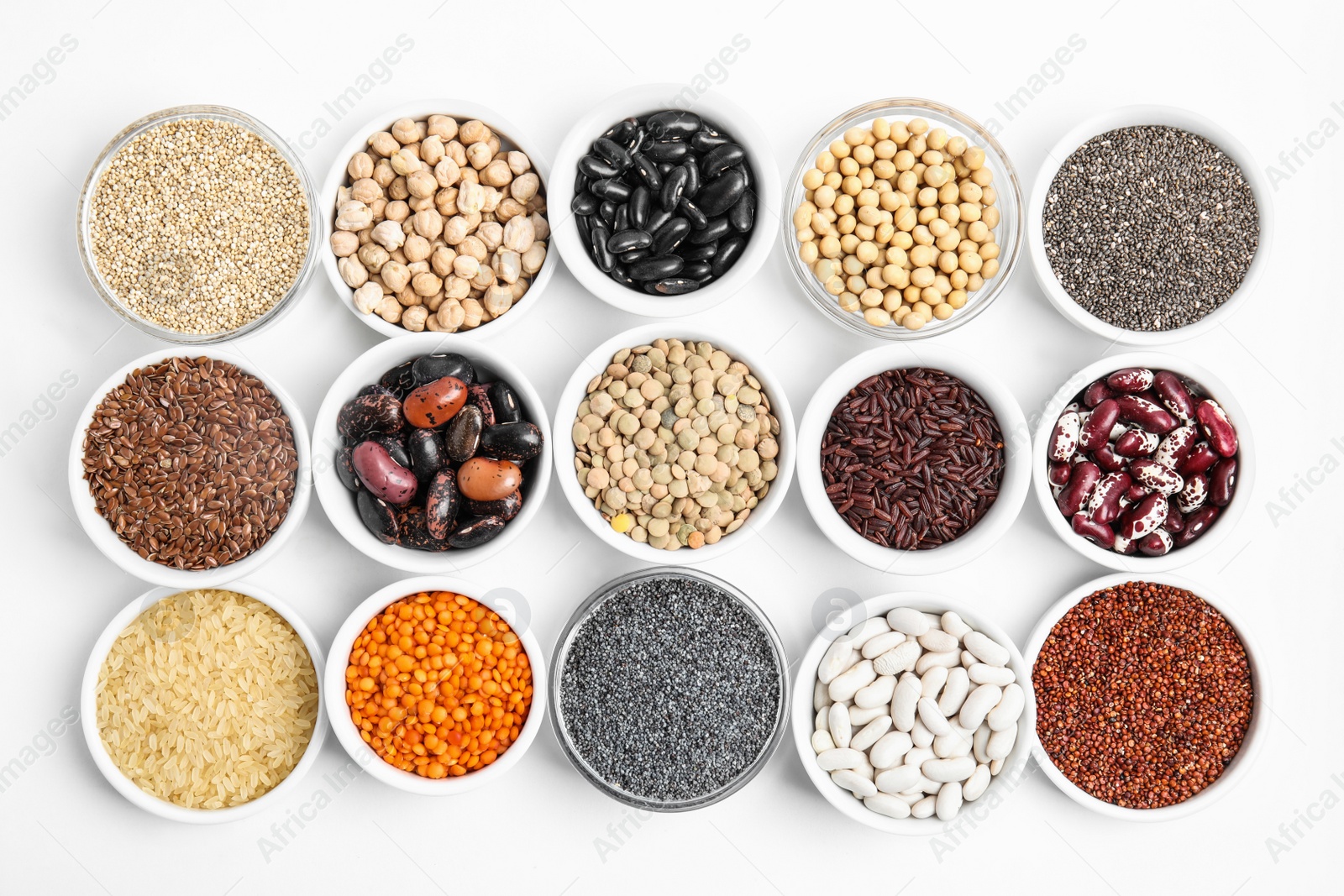 Photo of Various raw veggie seeds in bowls on white background, top view