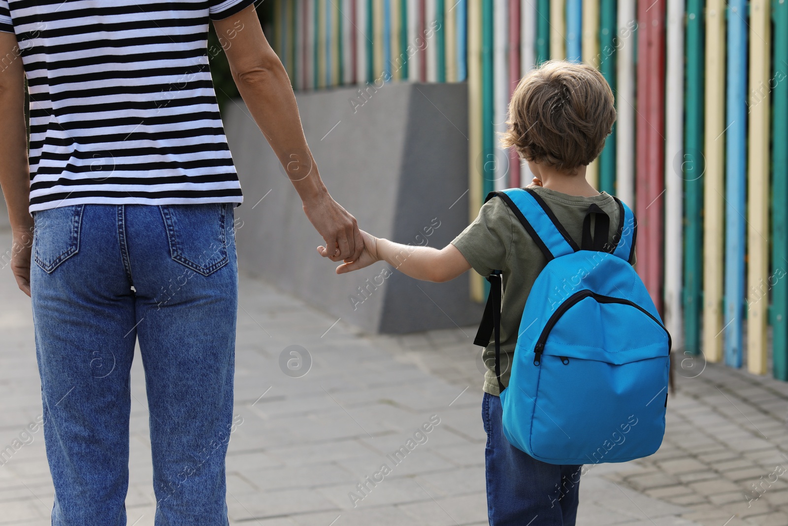 Photo of Woman and her little son on their way to kindergarten outdoors