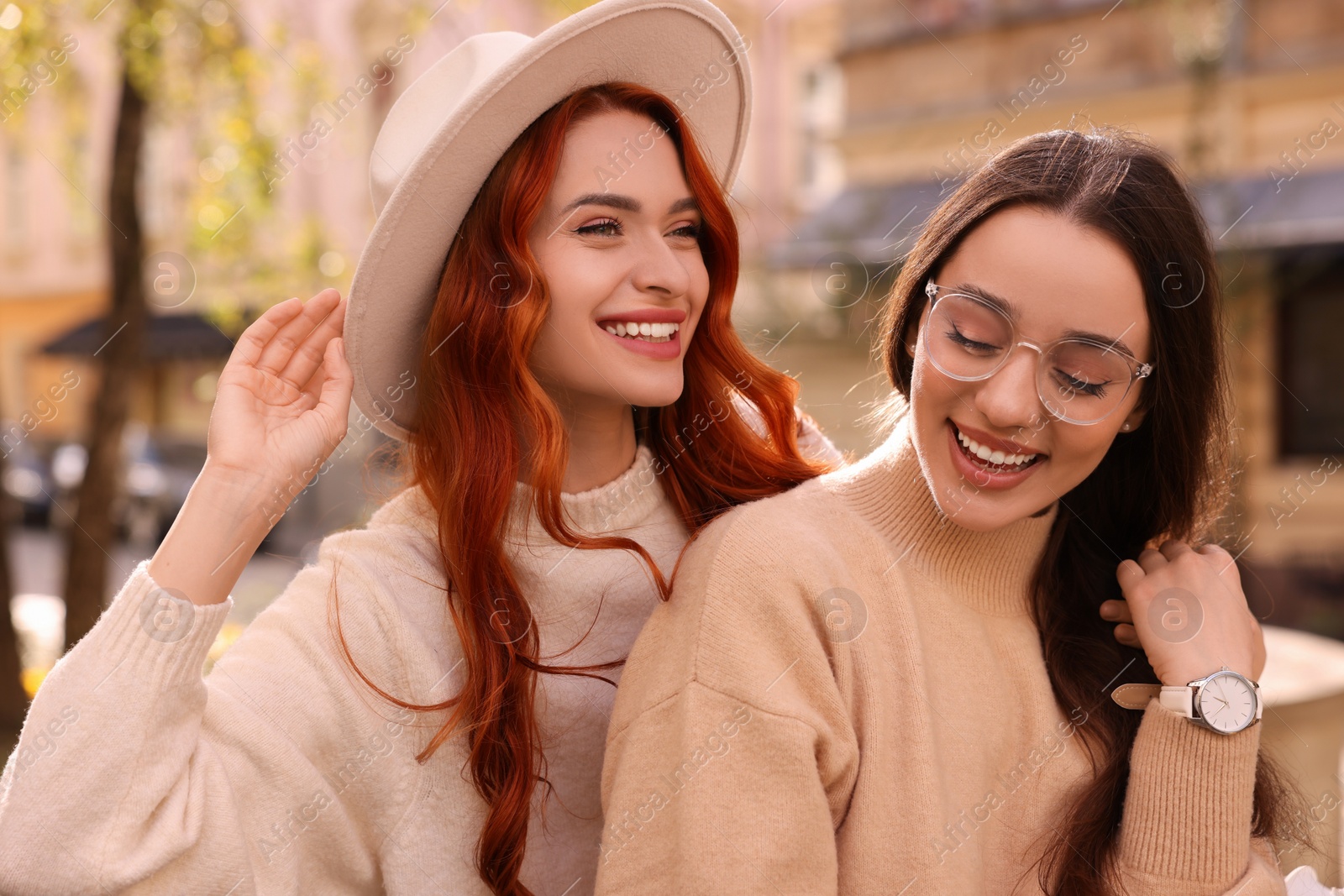 Photo of Happy friends spending time together outdoors on autumn day