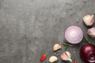 Photo of Flat lay composition with garlic, onion and space for text on table