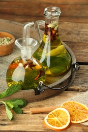 Photo of Cooking oil with different spices and herbs in jugs on white wooden table