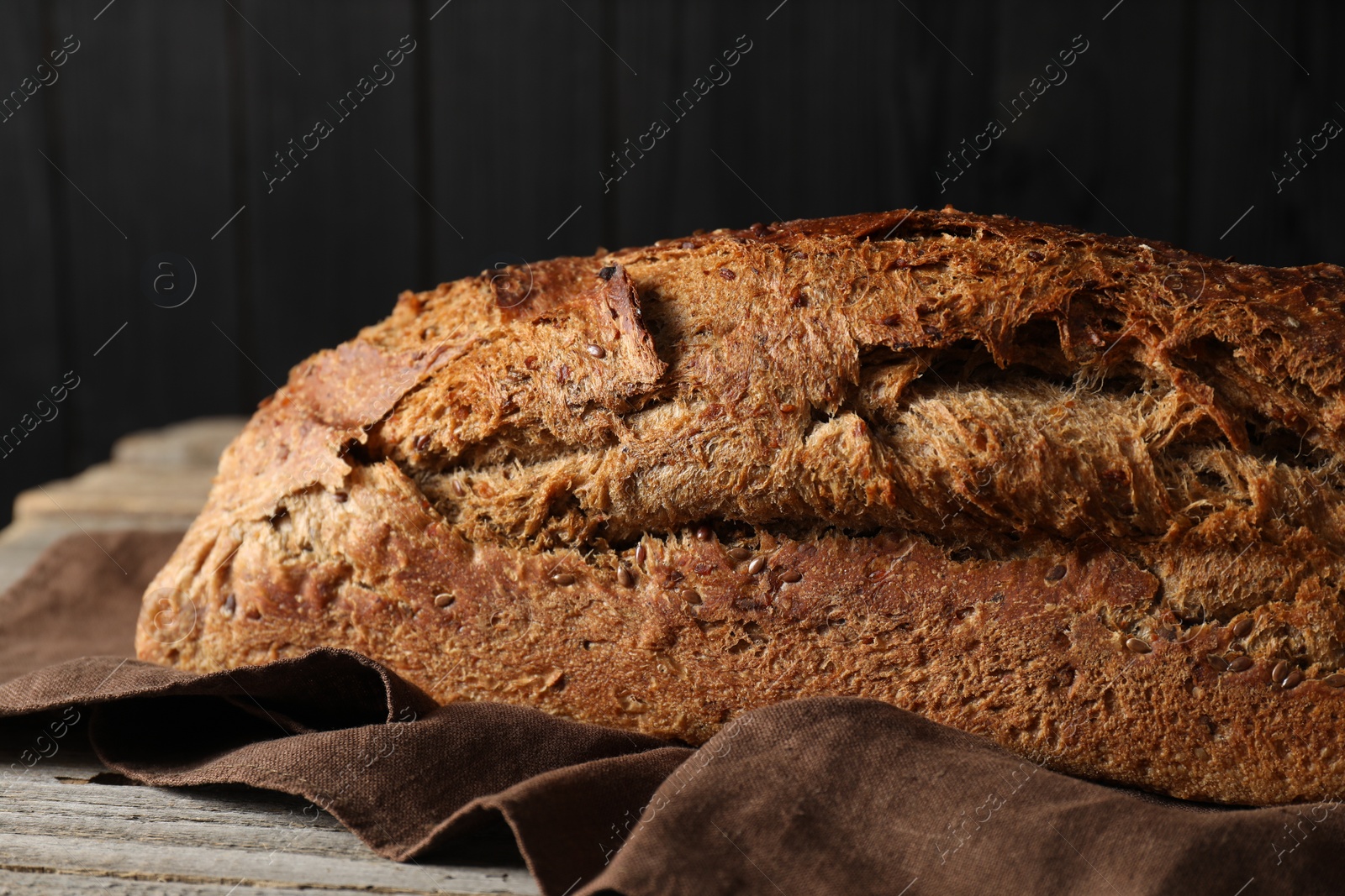 Photo of Freshly baked sourdough bread on wooden table, closeup