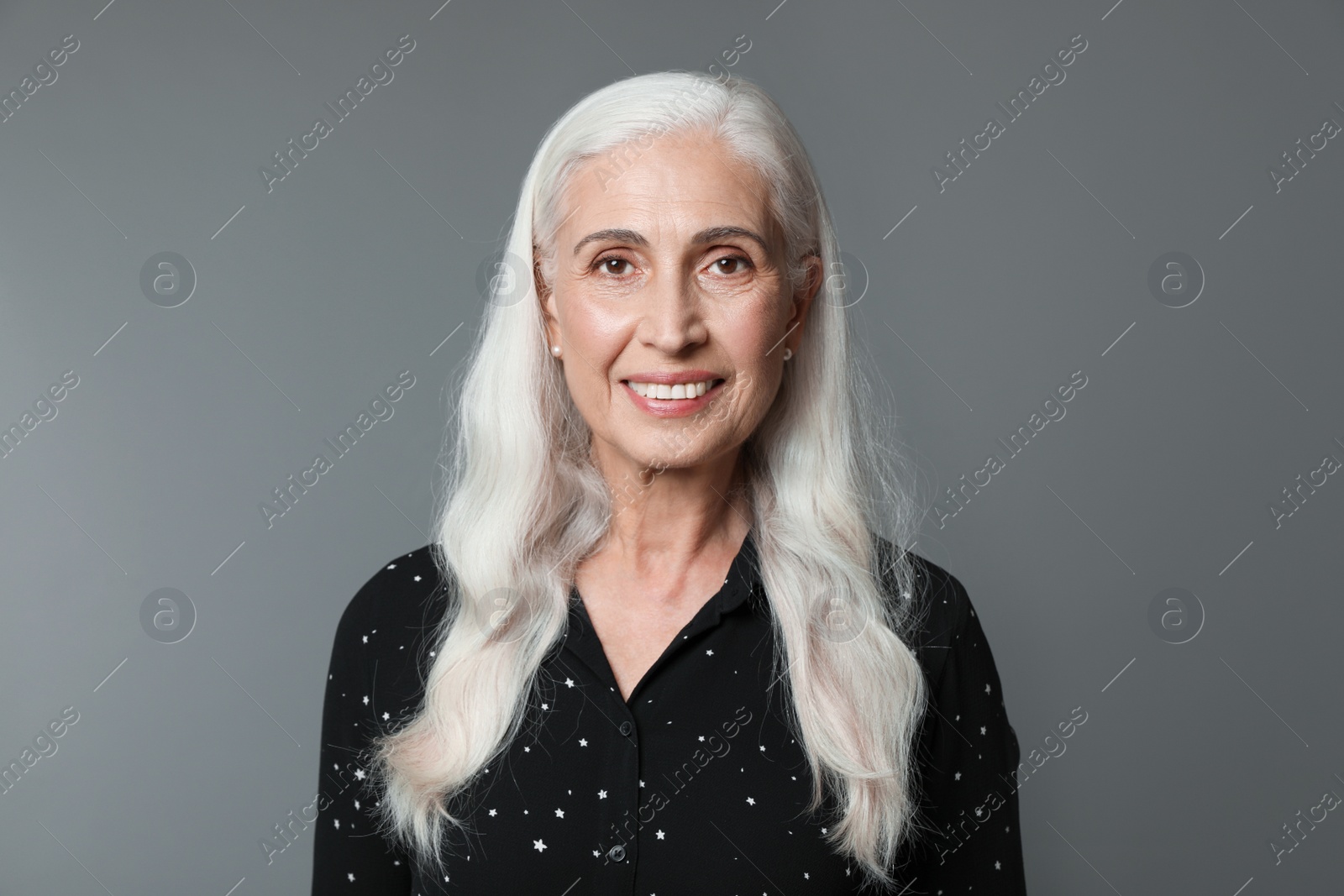 Photo of Portrait of beautiful mature woman on grey background