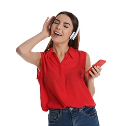 Beautiful young woman listening to music with headphones on white background