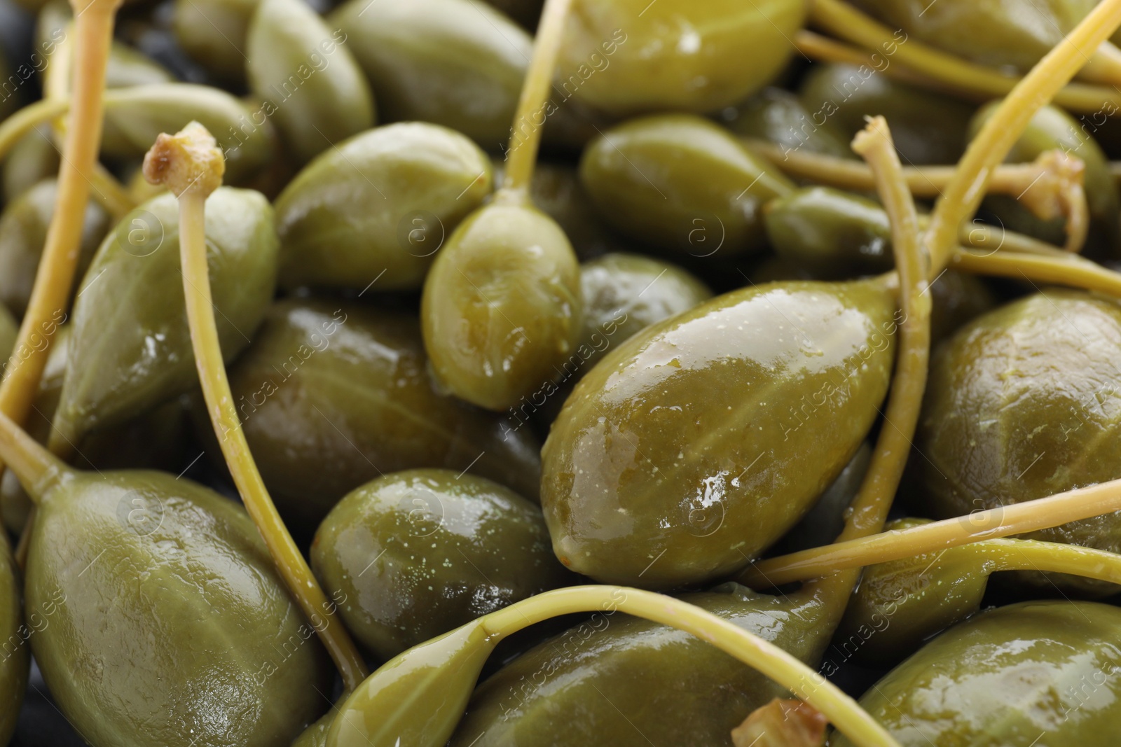 Photo of Pile of pickled capers as background, closeup view