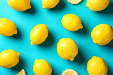 Flat lay composition with lemons on color background