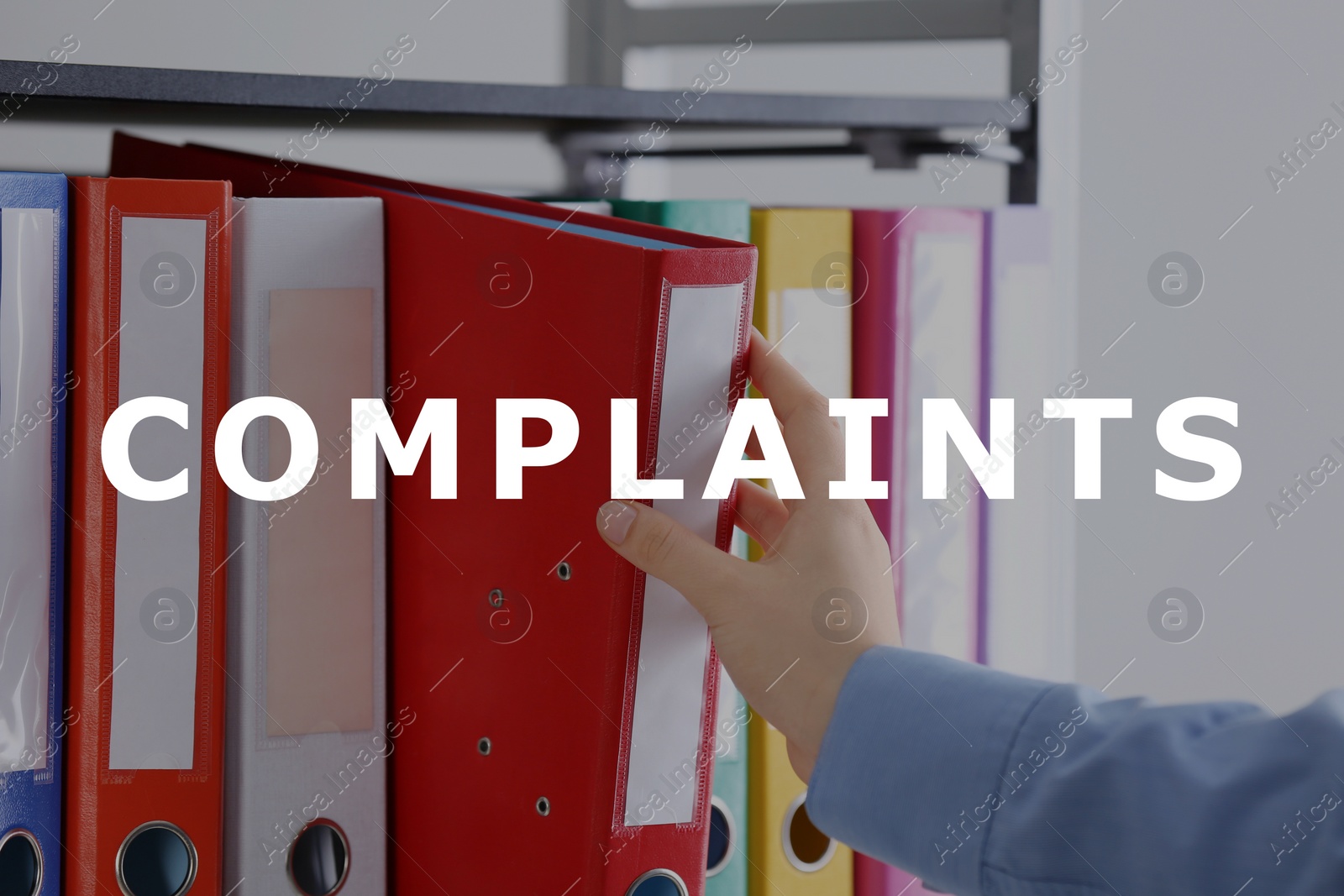 Image of Complaints archive. Woman taking folder with documents from shelf, closeup